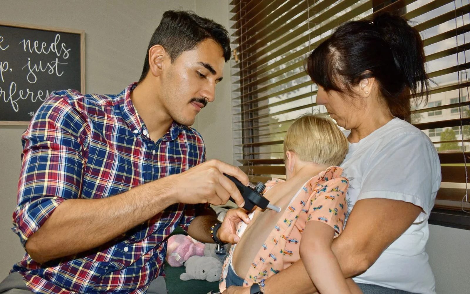 Dr. Pablo Gomez providing pediatric chiropractic care at Manifest Chiropractic
